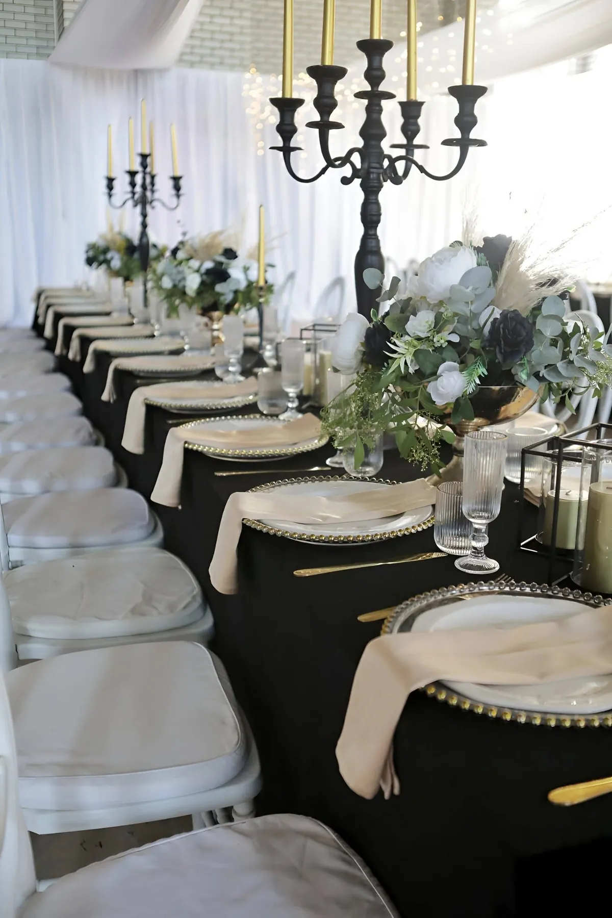 Long reception table with white chiavari chairs styled by Fabulous Events