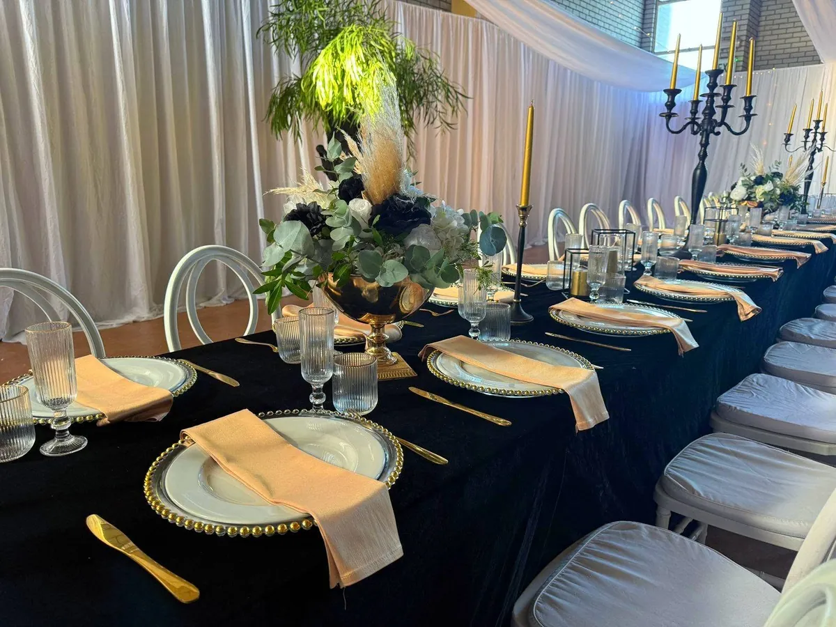 Elegant black and gold wedding table setting by Fabulous Events